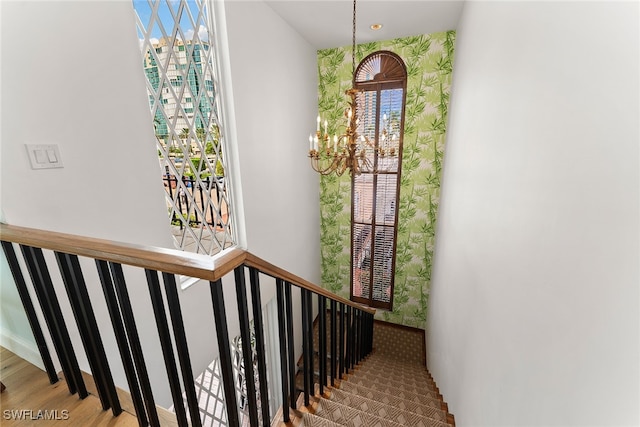 staircase with hardwood / wood-style floors and a healthy amount of sunlight