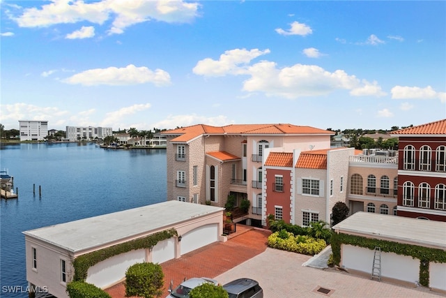 view of front of house featuring a water view and a balcony