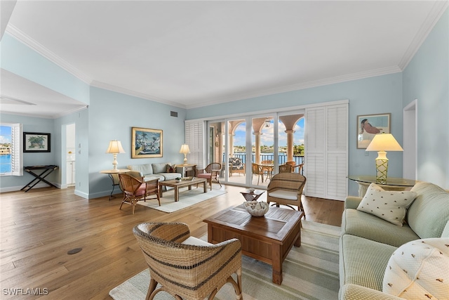 living room with ornamental molding and light wood-type flooring