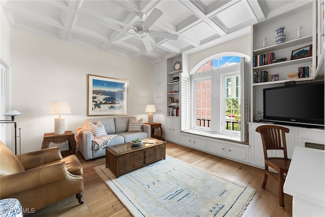 living room with coffered ceiling, beamed ceiling, light wood-type flooring, built in shelves, and ceiling fan