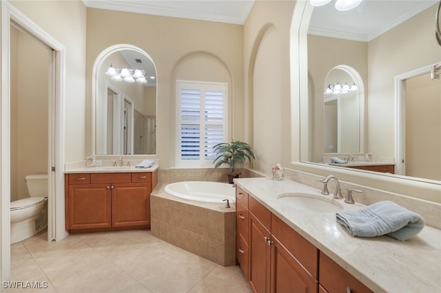 bathroom featuring tiled tub, vanity, crown molding, and toilet