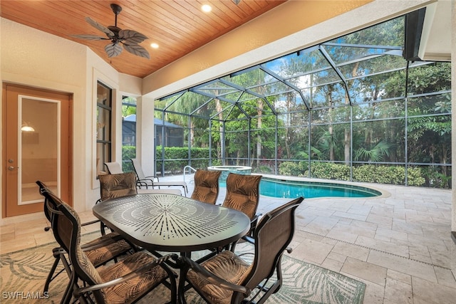 exterior space with ceiling fan and glass enclosure