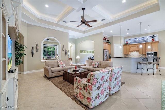 living room with ceiling fan, beamed ceiling, light tile patterned flooring, ornamental molding, and coffered ceiling