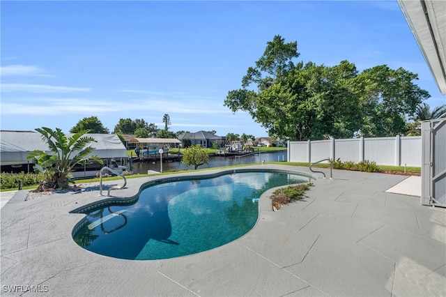 view of swimming pool featuring a patio area and a water view