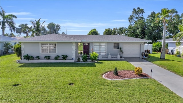 ranch-style house featuring a front yard and a garage