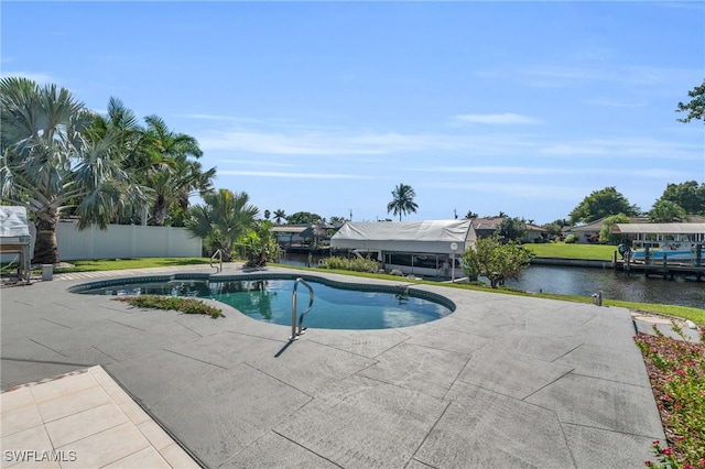 view of pool featuring a patio and a water view