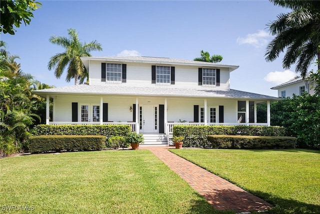 farmhouse-style home with a porch and a front lawn