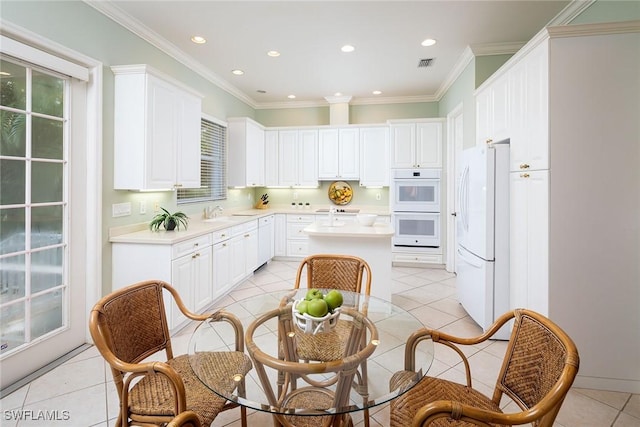 kitchen featuring light countertops, white appliances, light tile patterned flooring, and visible vents