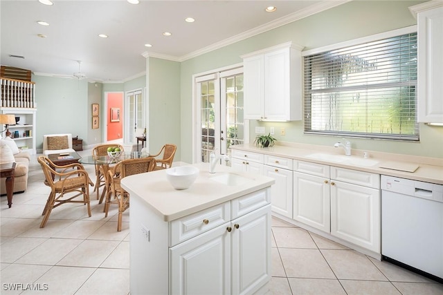 kitchen featuring ornamental molding, open floor plan, light tile patterned flooring, a sink, and dishwasher