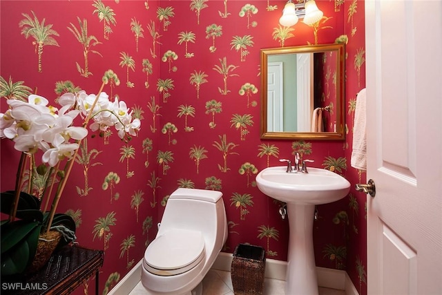 bathroom featuring baseboards, toilet, and tile patterned floors