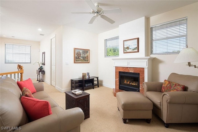 living room with light carpet, a healthy amount of sunlight, ceiling fan, and baseboards