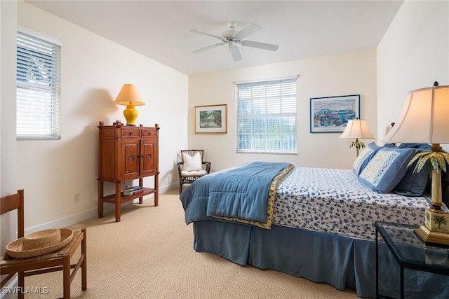 bedroom with light colored carpet and baseboards