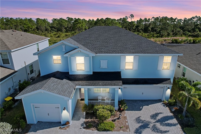 view of front of property featuring a garage and a porch