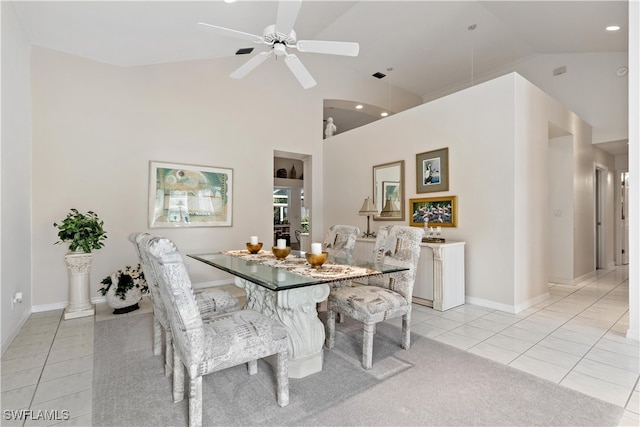 dining room with high vaulted ceiling, ceiling fan, and light tile patterned floors