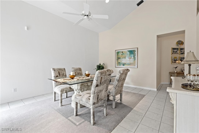 tiled dining area featuring ceiling fan and high vaulted ceiling