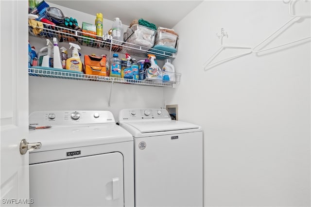 clothes washing area featuring separate washer and dryer