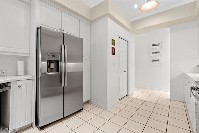 7539 Key Deer Ct, Fort Myers, FL 33966 - kitchen with light tile patterned floors, light countertops, white cabinetry, and appliances with stainless steel finishes