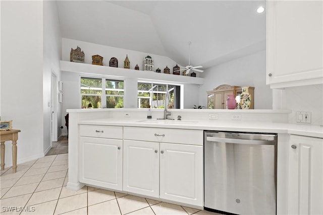 7539 Key Deer Ct, Fort Myers, FL 33966 - kitchen with white cabinets, light tile patterned flooring, dishwasher, a sink, and lofted ceiling