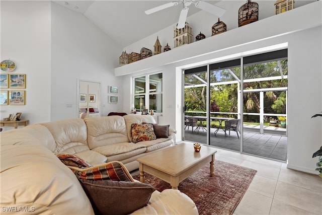 tiled living room featuring ceiling fan and high vaulted ceiling