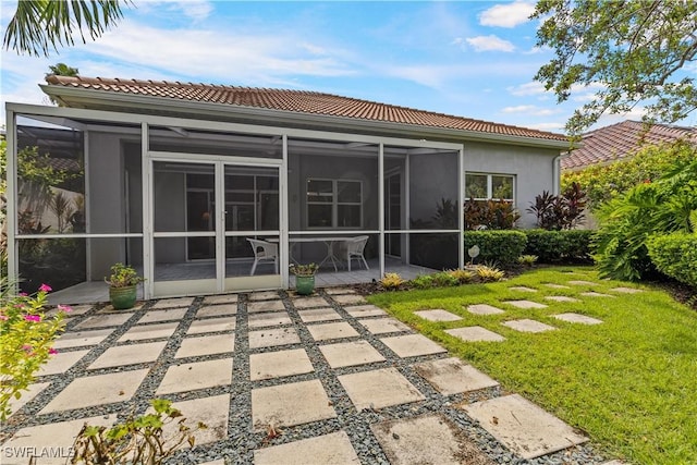 7539 Key Deer Ct, Fort Myers, FL 33966 - rear view of house featuring a tiled roof, a patio, a lawn, and stucco siding