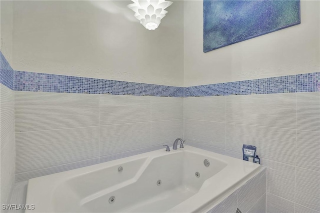 bathroom with a relaxing tiled tub