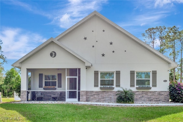 view of front of property with a sunroom and a front lawn