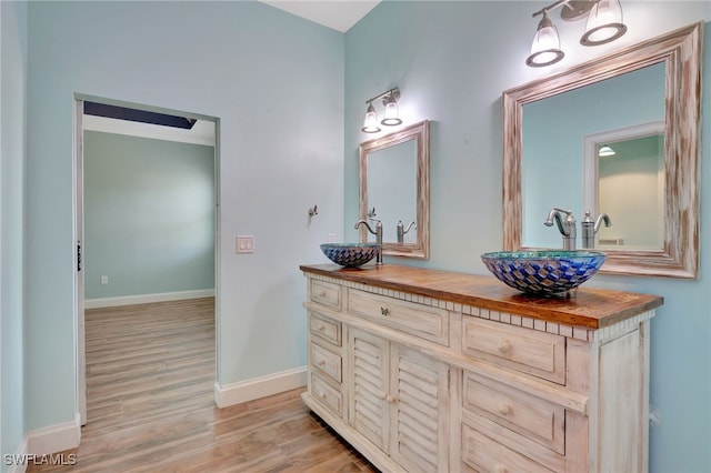 bathroom with hardwood / wood-style flooring and vanity