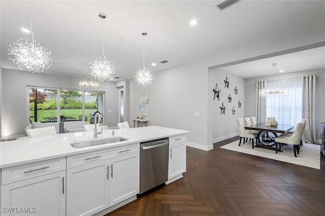 kitchen with decorative light fixtures, white cabinetry, stainless steel dishwasher, and sink