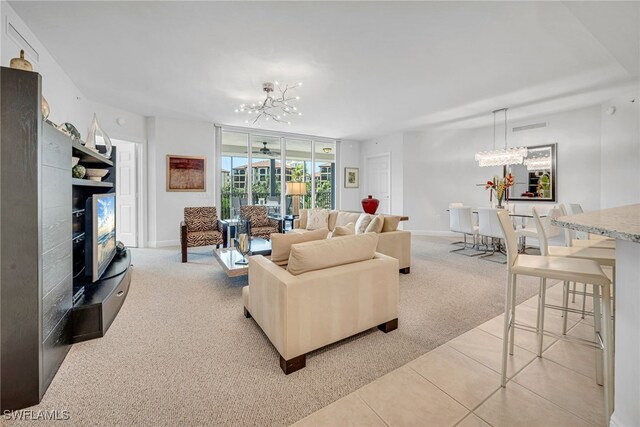 living room featuring a notable chandelier, visible vents, light tile patterned floors, and light carpet