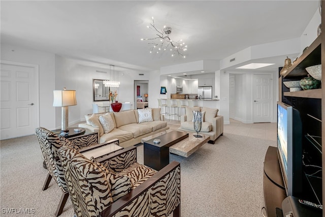 23540 Via Veneto Blvd Unit 202, Estero, FL 34134 - living room featuring light carpet, visible vents, baseboards, and an inviting chandelier