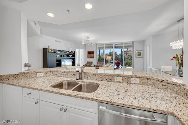 23540 Via Veneto Blvd Unit 202, Estero, FL 34134 - kitchen featuring a sink, a notable chandelier, dishwasher, and white cabinets