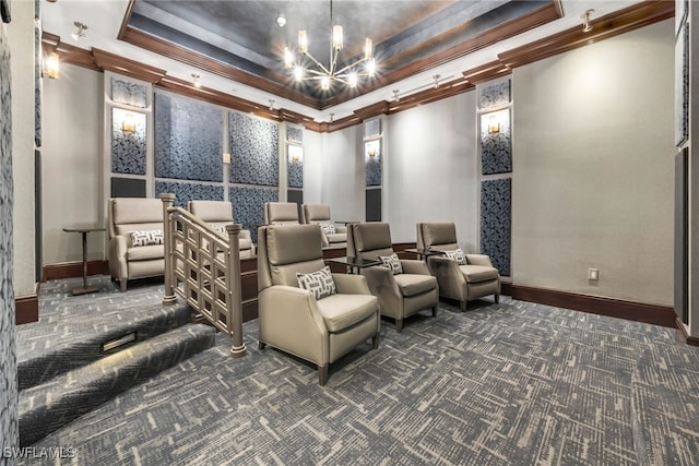 carpeted home theater featuring an inviting chandelier, a raised ceiling, crown molding, and baseboards