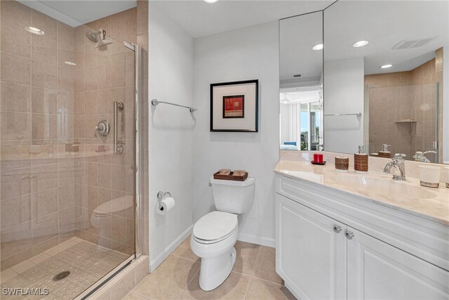 full bath featuring tile patterned flooring, a shower stall, baseboards, toilet, and vanity