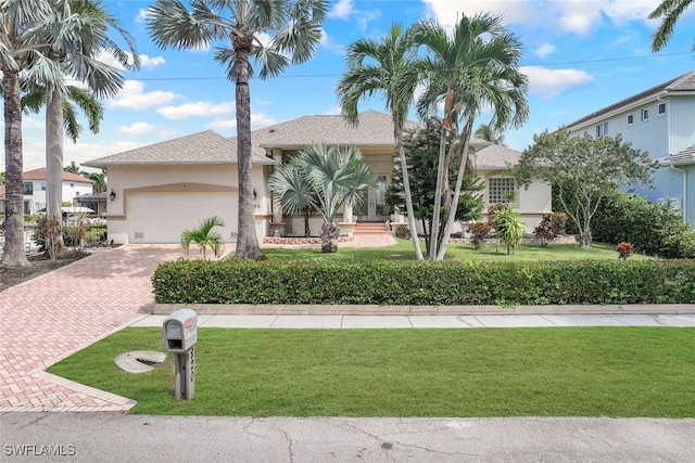 view of front of property with a front lawn and a garage