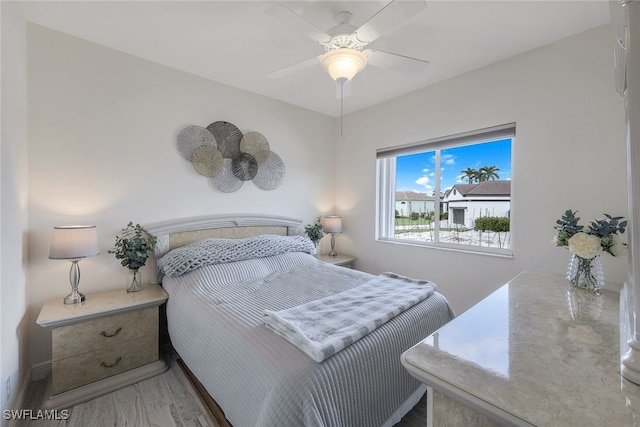 bedroom featuring ceiling fan and hardwood / wood-style flooring