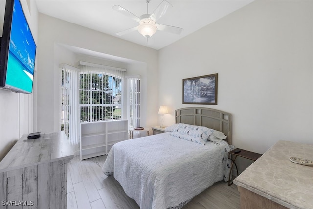 bedroom with ceiling fan and light hardwood / wood-style floors