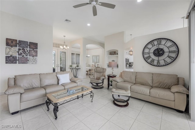 living room with ceiling fan with notable chandelier and light tile patterned floors