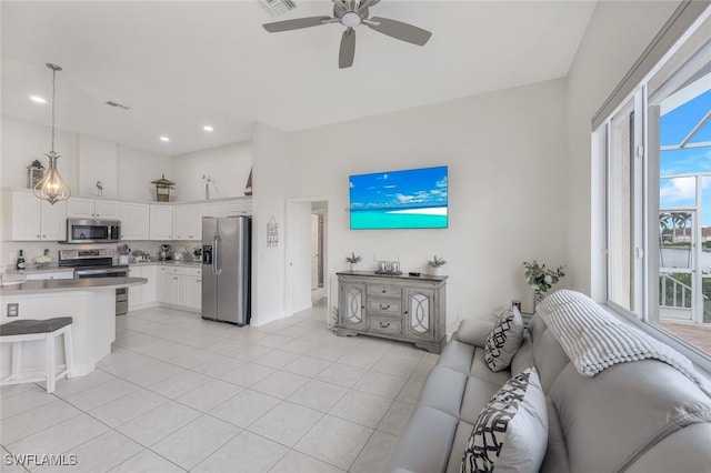 living room featuring light tile patterned floors and ceiling fan