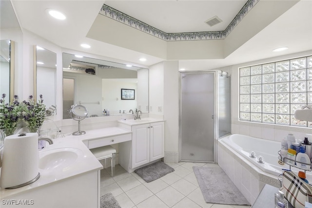 bathroom with tile patterned flooring, plus walk in shower, and vanity