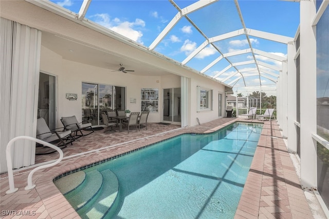 view of swimming pool featuring a lanai, ceiling fan, and a patio