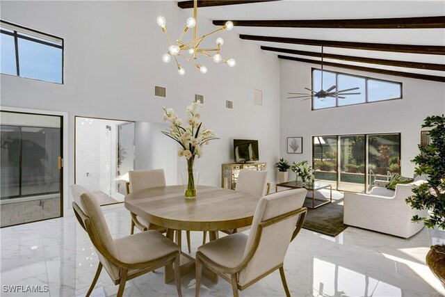 dining space featuring beam ceiling, ceiling fan with notable chandelier, high vaulted ceiling, and a healthy amount of sunlight