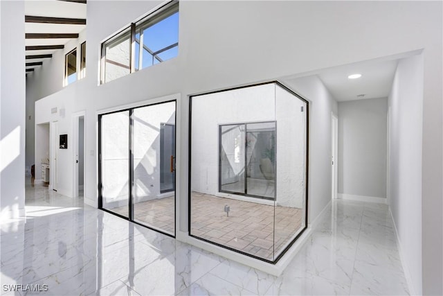 hallway featuring beam ceiling