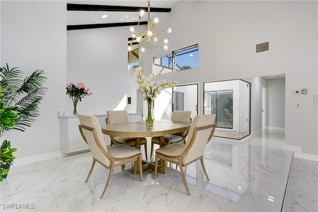 dining room featuring an inviting chandelier, beam ceiling, and a high ceiling