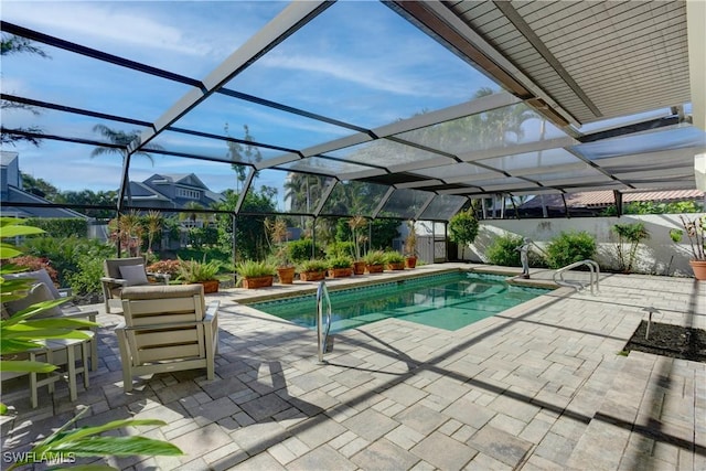 view of swimming pool with a patio and glass enclosure