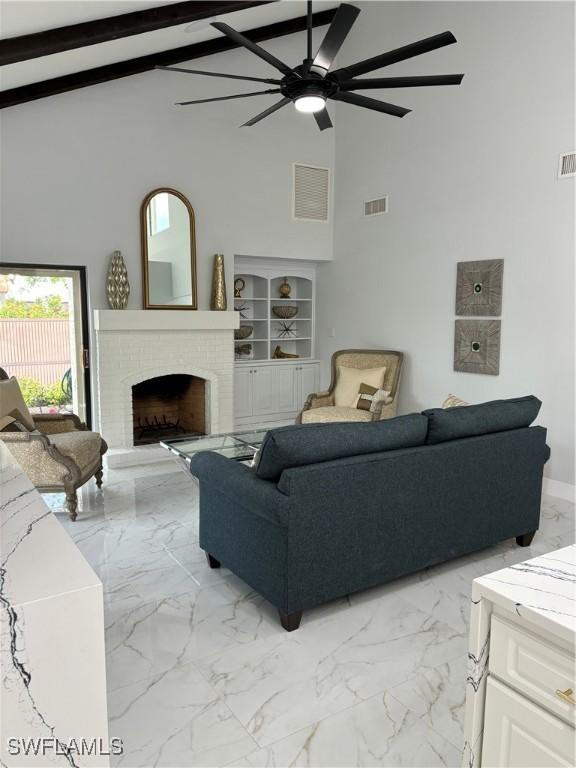 living room featuring beamed ceiling, a brick fireplace, built in features, and high vaulted ceiling