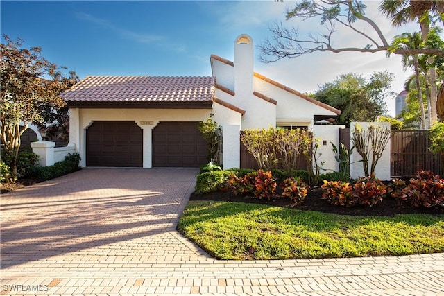 mediterranean / spanish house with a garage