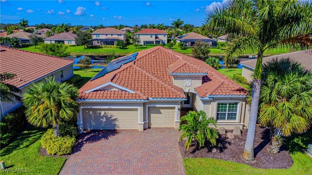 2251 Vermont Ln, Naples, FL 34120 - mediterranean / spanish-style house with a tile roof, a garage, stucco siding, and decorative driveway