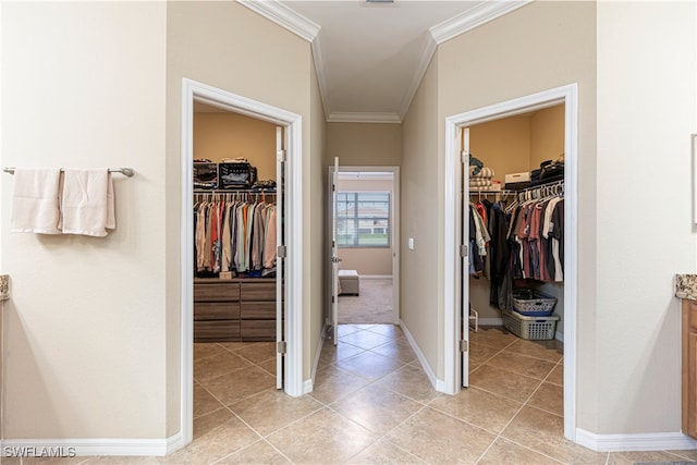 bathroom featuring tile patterned floors, crown molding, and vanity