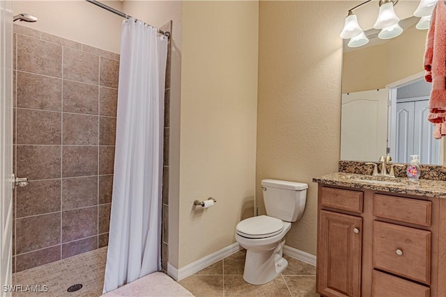 bathroom with curtained shower, tile patterned floors, vanity, and toilet