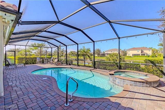 view of pool with glass enclosure, an in ground hot tub, and a patio area